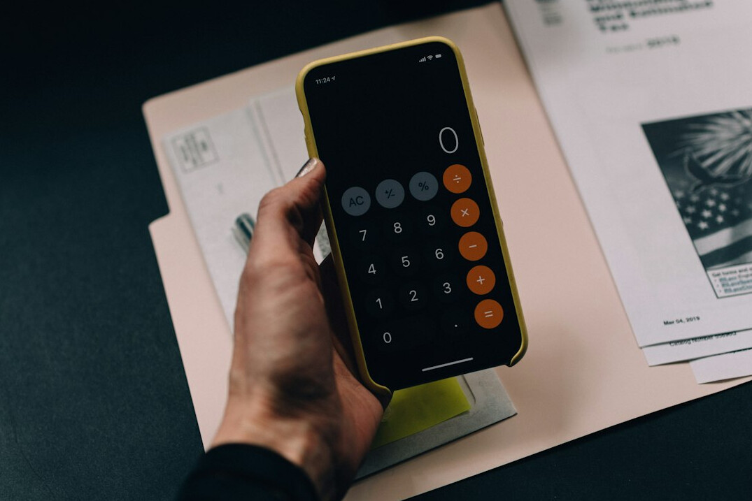 person calculating expenses on calculator